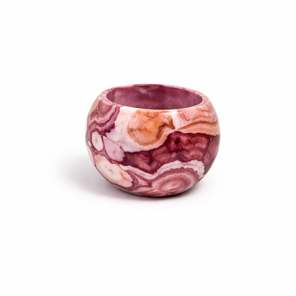 Round pink marble textured planter for small indoor plants.