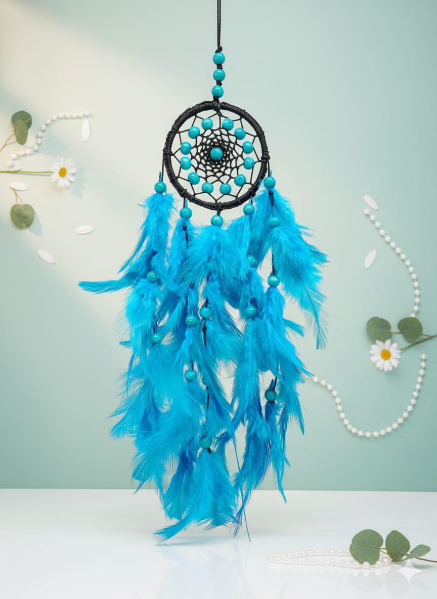A blue feather dreamcatcher with turquoise beads hangs against a light blue background.