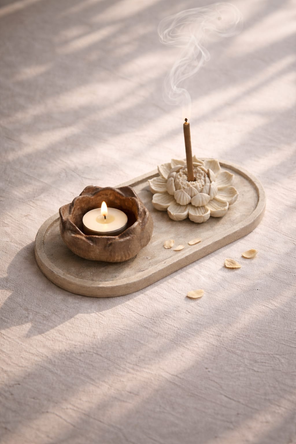 Candle and incense burner on a wooden tray with a light background