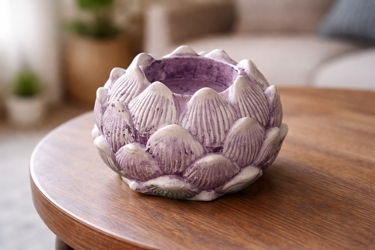 Ceramic lotus-shaped planter on a wooden table with a blurred indoor background