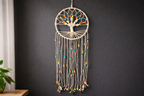 Decorative wall hanging with colorful beads on a dark wall