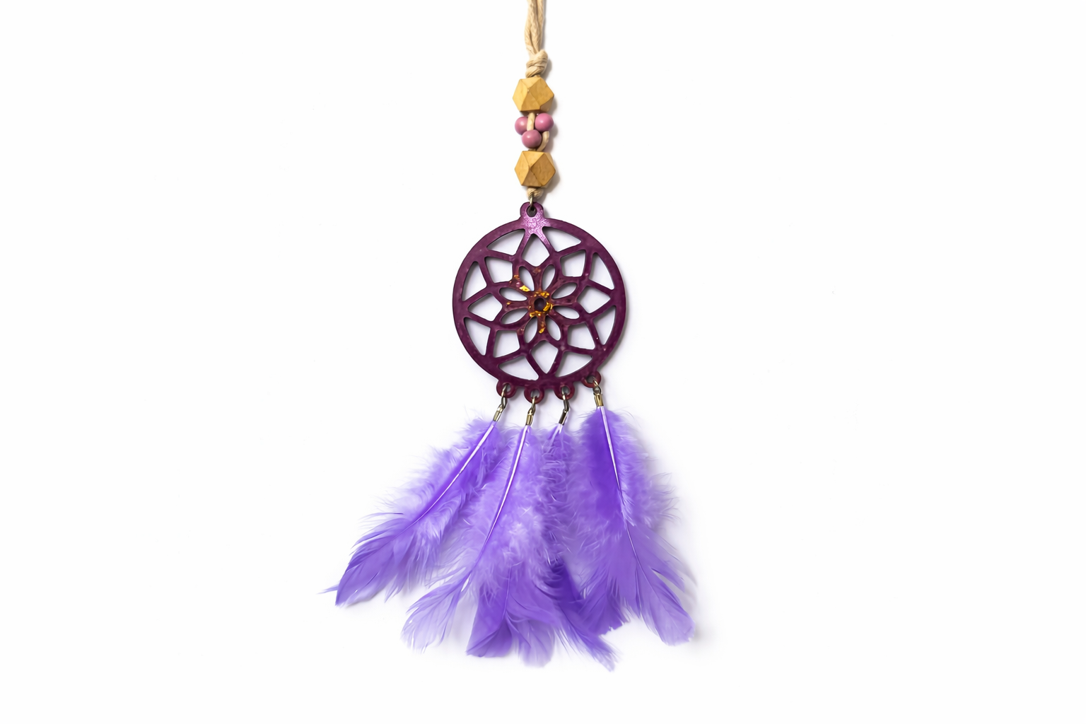 Decorative dreamcatcher with purple feathers on a white background
