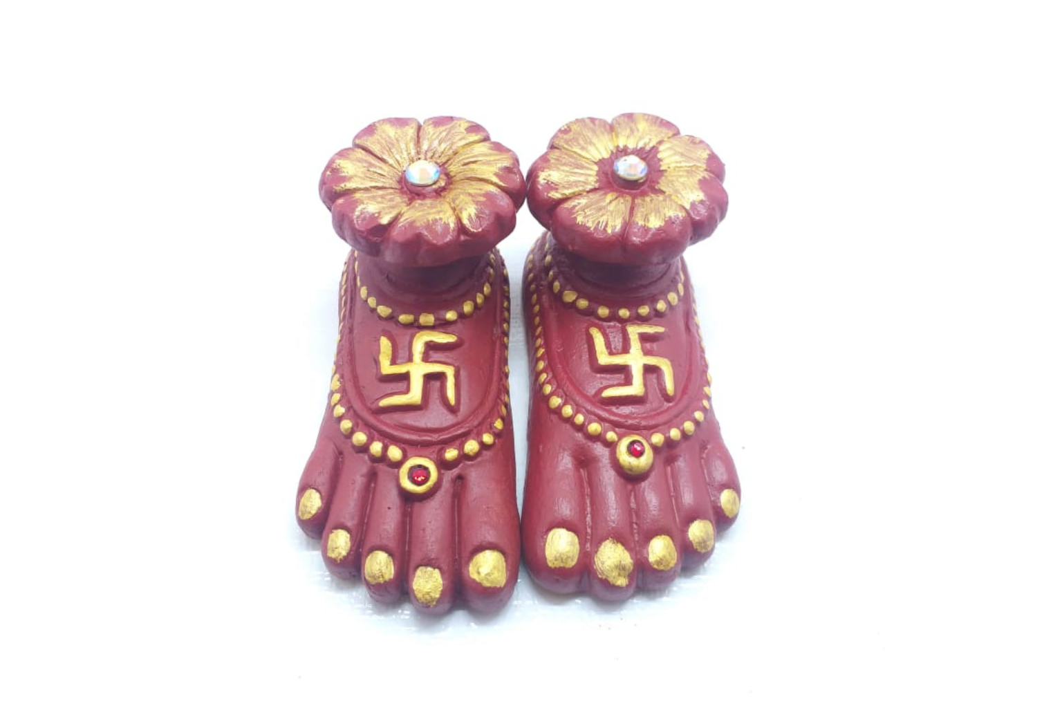 Decorative feet with swastika symbol on a white background