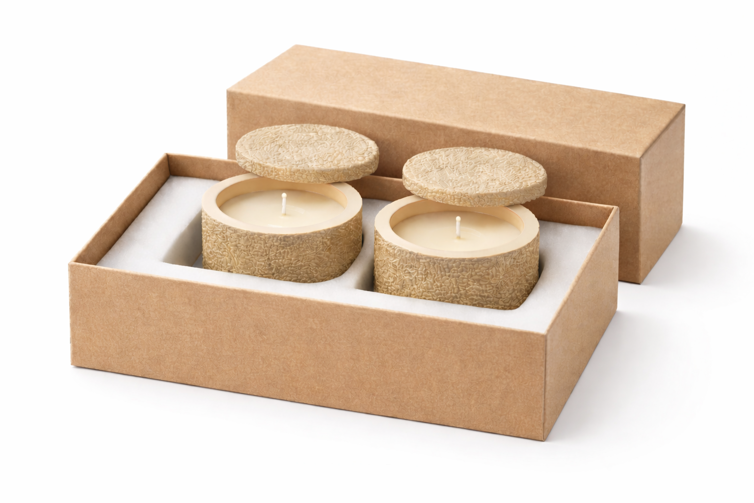 Three round candles in a cardboard box on a white background