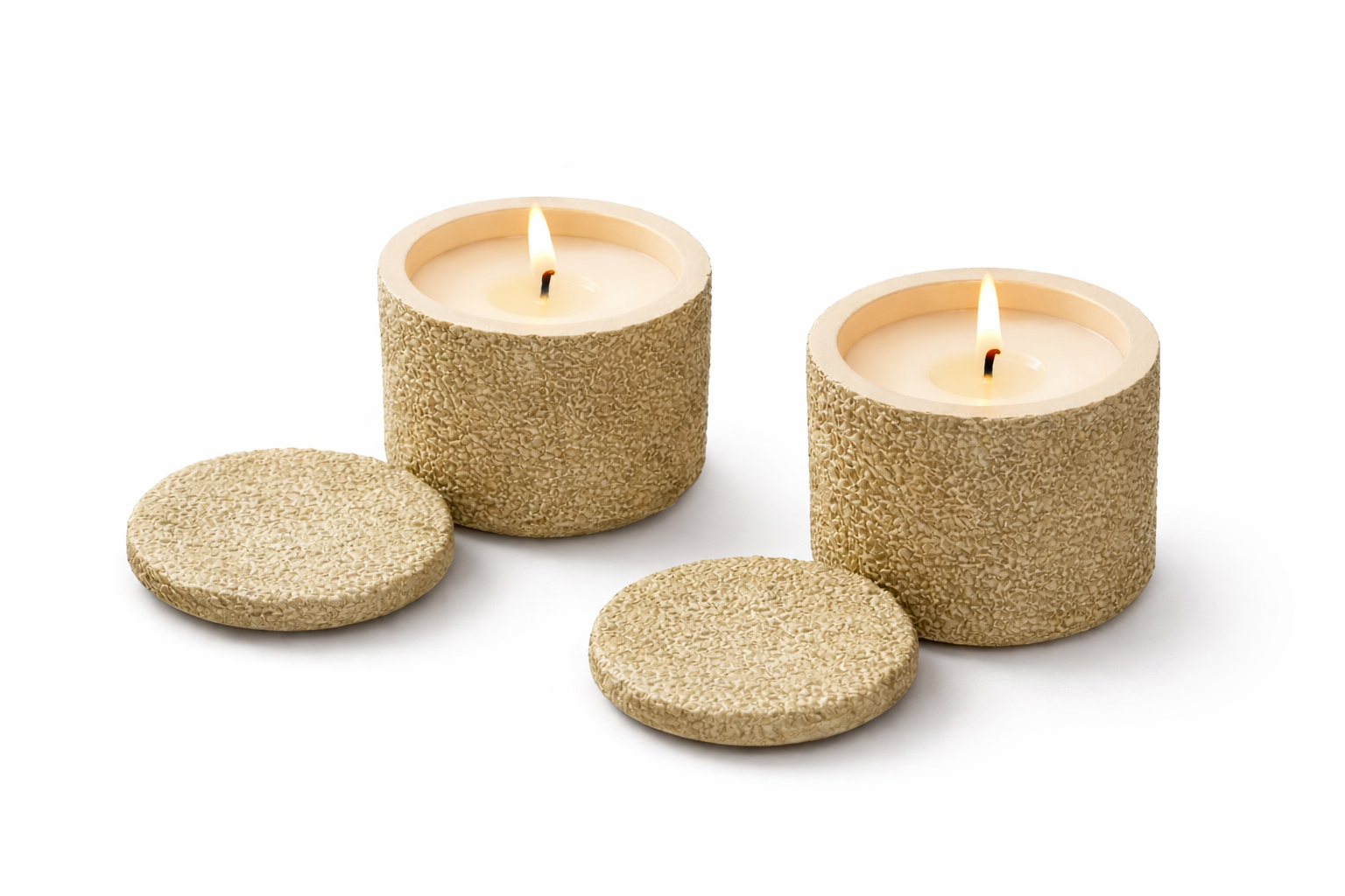 Two glittery gold candle holders with candles on a white background